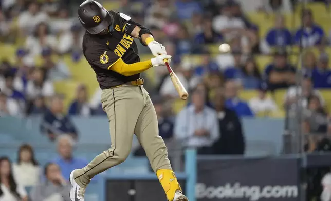 San Diego Padres' Kyle Higashioka connects for a solo home run during the ninth inning in Game 2 of a baseball NL Division Series against the Los Angeles Dodgers, Sunday, Oct. 6, 2024, in Los Angeles. (AP Photo/Mark J. Terrill)