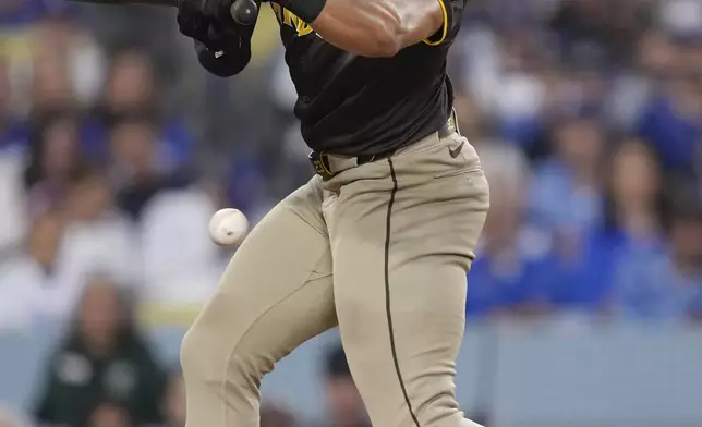 San Diego Padres' Fernando Tatis Jr. is hit by a pitch during the sixth inning in Game 2 of a baseball NL Division Series against the Los Angeles Dodgers, Sunday, Oct. 6, 2024, in Los Angeles. (AP Photo/Mark J. Terrill)