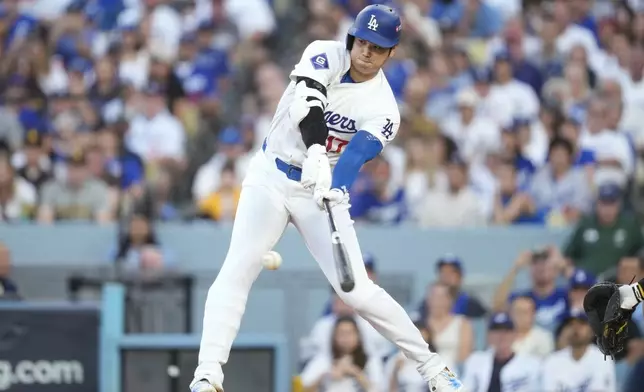 Los Angeles Dodgers' Shohei Ohtani grounds out during the third inning in Game 2 of a baseball NL Division Series against the San Diego Padres, Sunday, Oct. 6, 2024, in Los Angeles. (AP Photo/Ashley Landis)