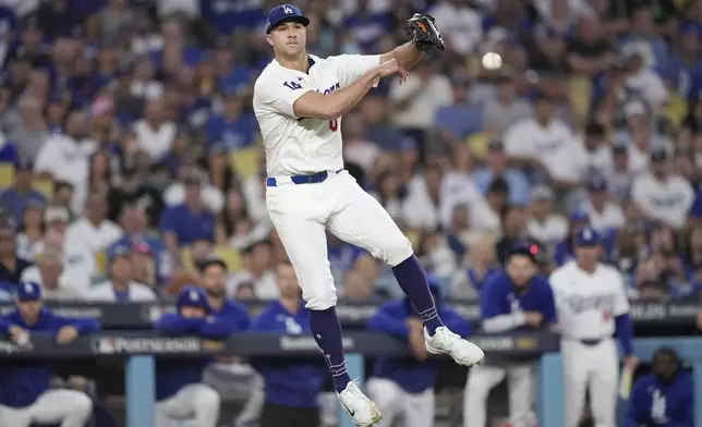 Los Angeles Dodgers pitcher Jack Flaherty throws to first base after a bunt single by San Diego Padres' Jurickson Profar during the sixth inning in Game 2 of a baseball NL Division Series, Sunday, Oct. 6, 2024, in Los Angeles. (AP Photo/Mark J. Terrill)