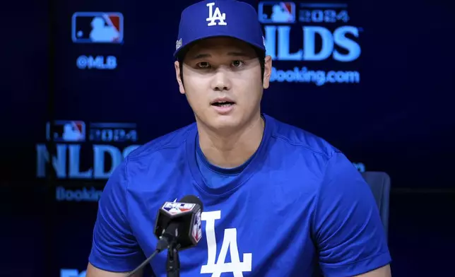 Los Angeles Dodgers' Shohei Ohtani speaks to reporters in a press conference in preparation for Game 1 of a baseball NL Division Series against the San Diego Padres in Los Angeles, Friday, Oct. 4, 2024. (AP Photo/Ashley Landis)