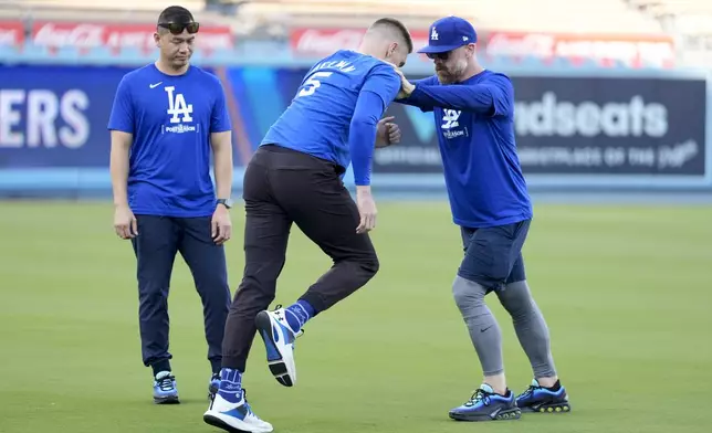 Los Angeles Dodgers' Freddie Freeman (5) works out ahead of Game 5 of a baseball NL Division Series against the San Diego Padres, Thursday, Oct. 10, 2024, in Los Angeles. (AP Photo/Ashley Landis)