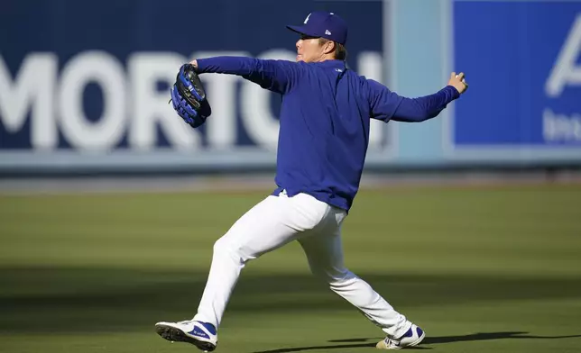 Los Angeles Dodgers pitcher Yoshinobu Yamamoto throws on the field ahead of Game 5 of a baseball NL Division Series between the Los Angeles Dodgers and the San Diego Padres, Thursday, Oct. 10, 2024, in Los Angeles. (AP Photo/Ashley Landis)