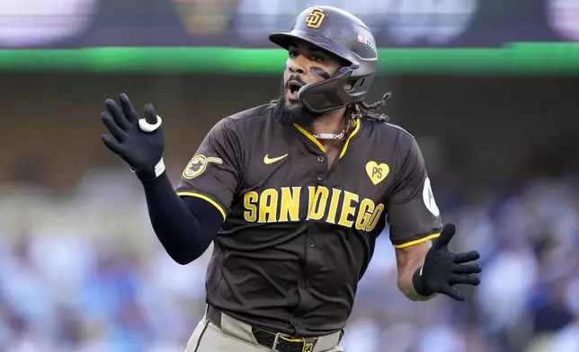 San Diego Padres' Fernando Tatis Jr. celebrates as he rounds first base after a solo home run during the first inning in Game 2 of a baseball NL Division Series against the Los Angeles Dodgers, Sunday, Oct. 6, 2024, in Los Angeles. (AP Photo/Mark J. Terrill)