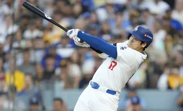 Los Angeles Dodgers' Shohei Ohtani flies out against the San Diego Padres during the first inning in Game 1 of baseball's NL Division Series Saturday, Oct. 5, 2024, in Los Angeles. (AP Photo/Ashley Landis)