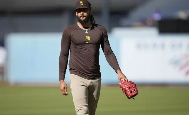 San Diego Padres' Fernando Tatis Jr. walks on the field before Game 5 of a baseball NL Division Series against the Los Angeles Dodgers, Friday, Oct. 11, 2024, in Los Angeles. (AP Photo/Ashley Landis)