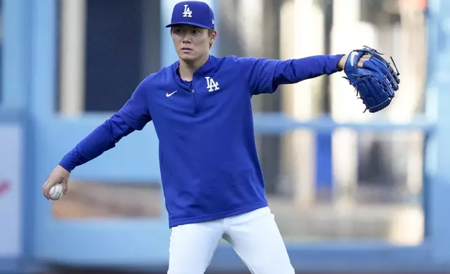 Los Angeles Dodgers pitcher Yoshinobu Yamamoto throws on the field ahead of Game 5 of a baseball National League Division Series against the San Diego Padres, Thursday, Oct. 10, 2024, in Los Angeles. (AP Photo/Ashley Landis)