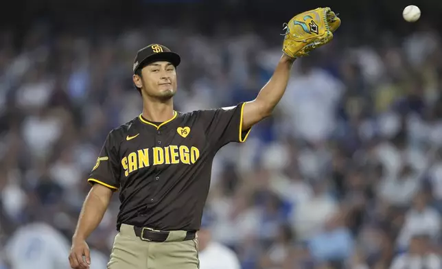 San Diego Padres pitcher Yu Darvish gets a ball back as he pitches during the fifth inning in Game 5 of a baseball NL Division Series against the Los Angeles Dodgers, Friday, Oct. 11, 2024, in Los Angeles. (AP Photo/Ashley Landis)