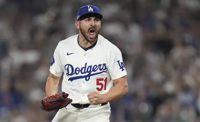 Los Angeles Dodgers relief pitcher Alex Vesia celebrates after striking out San Diego Padres' Jackson Merrill during the seventh inning in Game 5 of a baseball NL Division Series Friday, Oct. 11, 2024, in Los Angeles. (AP Photo/Ashley Landis)