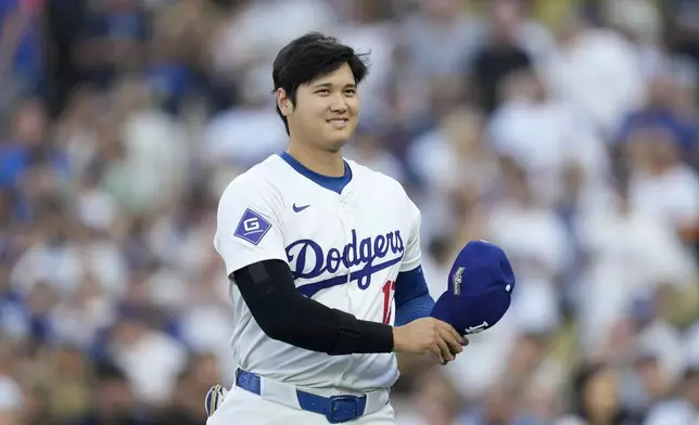 Los Angeles Dodgers' Shohei Ohtani walks back to the dugout before Game 1 of baseball's NL Division Series against the San Diego Padres, Saturday, Oct. 5, 2024, in Los Angeles. (AP Photo/Ashley Landis)