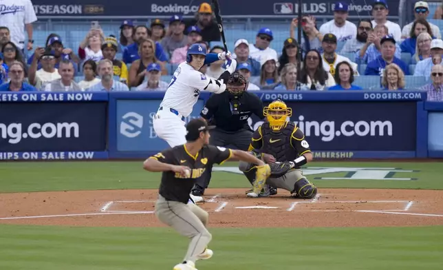 San Diego Padres pitcher Yu Darvish, bottom center, throws to Los Angeles Dodgers' Shohei Ohtani during the first inning in Game 5 of a baseball NL Division Series Friday, Oct. 11, 2024, in Los Angeles. (AP Photo/Mark J. Terrill)