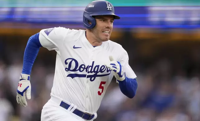 Los Angeles Dodgers' Freddie Freeman runs to first base as he singles during the first inning in Game 5 of a baseball NL Division Series against the San Diego Padres, Friday, Oct. 11, 2024, in Los Angeles. (AP Photo/Mark J. Terrill)