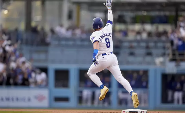 Los Angeles Dodgers' Kiké Hernández celebrates as he rounds second base following his solo home run during the second inning in Game 5 of a baseball NL Division Series against the San Diego Padres, Friday, Oct. 11, 2024, in Los Angeles. (AP Photo/Mark J. Terrill)