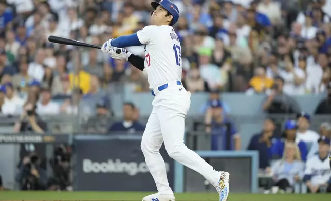 Los Angeles Dodgers' Shohei Ohtani flies out against the San Diego Padres during the first inning in Game 1 of baseball's NL Division Series Saturday, Oct. 5, 2024, in Los Angeles. (AP Photo/Ashley Landis)