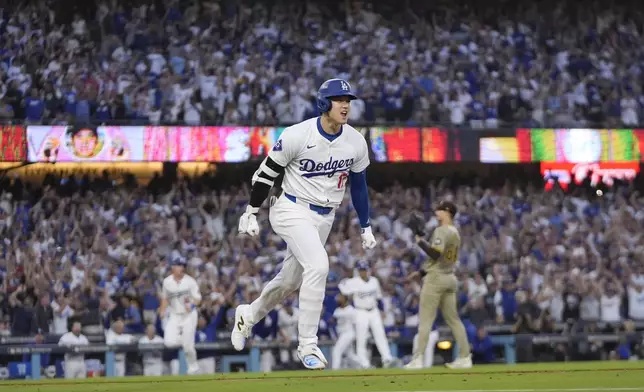 Los Angeles Dodgers' Shohei Ohtani reacts as he rounds first base following his three-run home run during the second inning in Game 1 of baseball's NL Division Series against the San Diego Padres, Saturday, Oct. 5, 2024, in Los Angeles. (AP Photo/Mark J. Terrill)