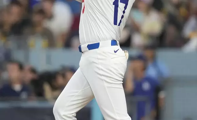 Los Angeles Dodgers' Shohei Ohtani watches his three-run home run during the second inning in Game 1 of baseball's NL Division Series against the San Diego Padres, Saturday, Oct. 5, 2024, in Los Angeles. (AP Photo/Ashley Landis)