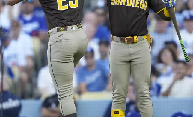 San Diego Padres' Fernando Tatis Jr., left, celebrates his solo home run with Jurickson Profar during the first inning in Game 2 of a baseball NL Division Series against the Los Angeles Dodgers, Sunday, Oct. 6, 2024, in Los Angeles.