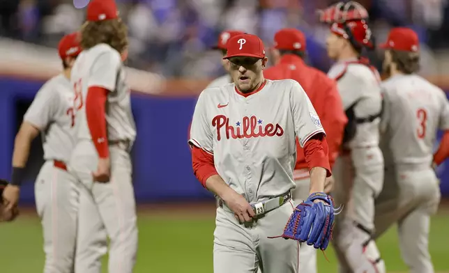 Philadelphia Phillies pitcher Jeff Hoffman walks off the field after walking the bases loaded against the New York Mets during the sixth inning of Game 4 of the National League baseball playoff series, Wednesday, Oct. 9, 2024, in New York. (AP Photo/Adam Hunger)