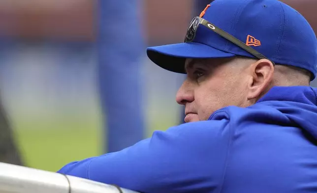 New York Mets manager Carlos Mendoza watches batting practice before Game 3 of the National League baseball playoff series against the Philadelphia Phillies, Tuesday, Oct. 8, 2024, in New York. (AP Photo/Frank Franklin II)