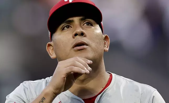 Philadelphia Phillies pitcher Ranger Suárez walks off the field at the end of the second inning of Game 4 of the National League baseball playoff series against the New York Mets, Wednesday, Oct. 9, 2024, in New York. (AP Photo/Adam Hunger)