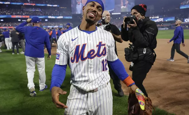 New York Mets shortstop Francisco Lindor (12) celebrates after the New York Mets beat the Philadelphia Phillies in Game 4 of the National League baseball playoff series, Wednesday, Oct. 9, 2024, in New York. (AP Photo/Adam Hunger)