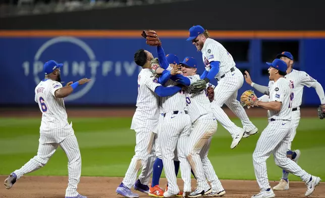 The New York Mets celebrate after defeating the Philadelphia Phillies in Game 4 of the National League baseball playoff series, Wednesday, Oct. 9, 2024, in New York. (AP Photo/Frank Franklin II)