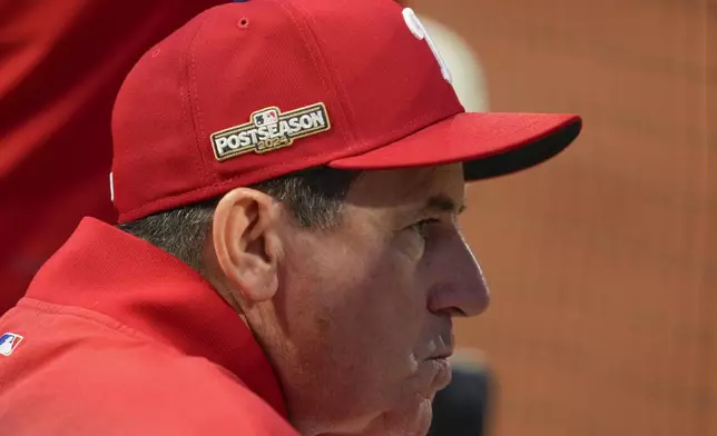 Philadelphia Phillies manager Rob Thomson (59) watches play against the New York Mets from the dugout during the fourth inning of Game 3 of the National League baseball playoff series, Tuesday, Oct. 8, 2024, in New York. (AP Photo/Seth Wenig)