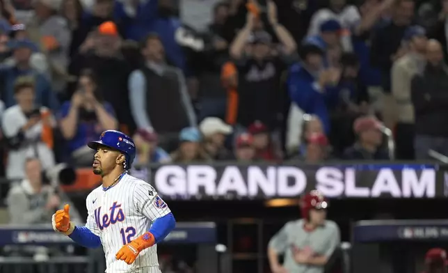 New York Mets' Francisco Lindor (12) rounds the bases after hitting a grand slam home run against the Philadelphia Phillies during the sixth inning of Game 4 of the National League baseball playoff series, Wednesday, Oct. 9, 2024, in New York. (AP Photo/Frank Franklin II)