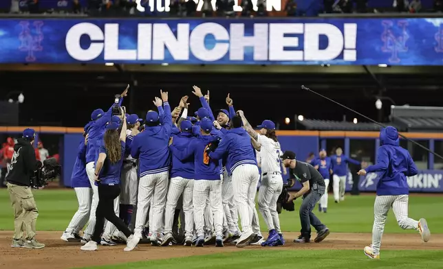 The New York Mets celebrate after defeating the Philadelphia Phillies in Game 4 of the National League baseball playoff series, Wednesday, Oct. 9, 2024, in New York. (AP Photo/Adam Hunger)