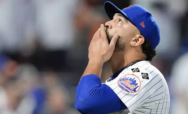 New York Mets pitcher Sean Manaea (59) reacts as he walks off the field at the end of the top of the seventh inning of Game 3 of the National League baseball playoff series against the Philadelphia Phillies, Tuesday, Oct. 8, 2024, in New York. (AP Photo/Frank Franklin II)