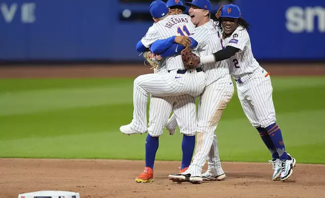 The New York Mets celebrate after defeating the Philadelphia Phillies in Game 4 of the National League baseball playoff series, Wednesday, Oct. 9, 2024, in New York. (AP Photo/Frank Franklin II)