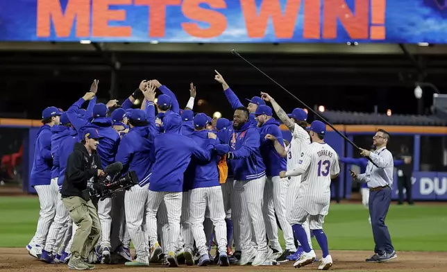 The New York Mets celebrate after defeating the Philadelphia Phillies in Game 4 of the National League baseball playoff series, Wednesday, Oct. 9, 2024, in New York. (AP Photo/Adam Hunger)