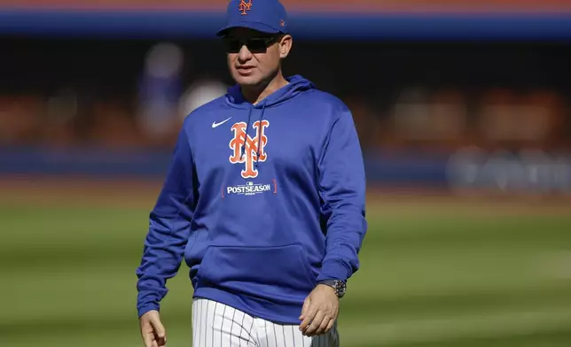 New York Mets manager Carlos Mendoza walks on the field before Game 4 of the National League baseball playoff series against the Philadelphia Phillies, Wednesday, Oct. 9, 2024, in New York. (AP Photo/Adam Hunger)