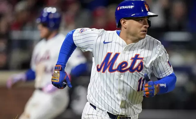 New York Mets' Jose Iglesias (11) heads for first after driving in two runs on a base hit against the Philadelphia Phillies during the seventh inning of Game 3 of the National League baseball playoff series, Tuesday, Oct. 8, 2024, in New York. (AP Photo/Frank Franklin II)