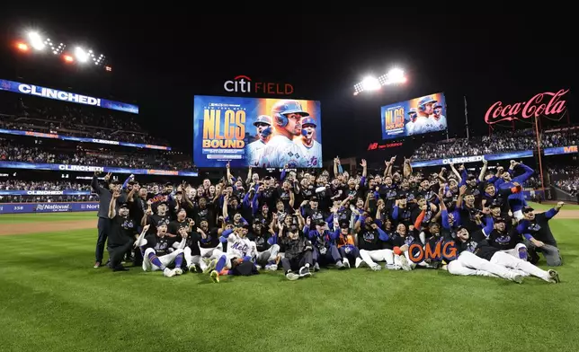 The New York Mets pose for a group photo on the field after defeating the Philadelphia Phillies in Game 4 of the National League baseball playoff series, Wednesday, Oct. 9, 2024, in New York. (AP Photo/Adam Hunger)