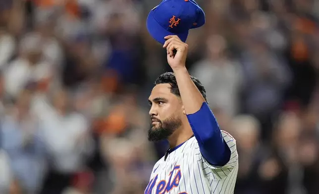 New York Mets pitcher Sean Manaea (59) reacts as he walks off the field during the eighth inning of Game 3 of the National League baseball playoff series against the Philadelphia Phillies, Tuesday, Oct. 8, 2024, in New York. (AP Photo/Frank Franklin II)