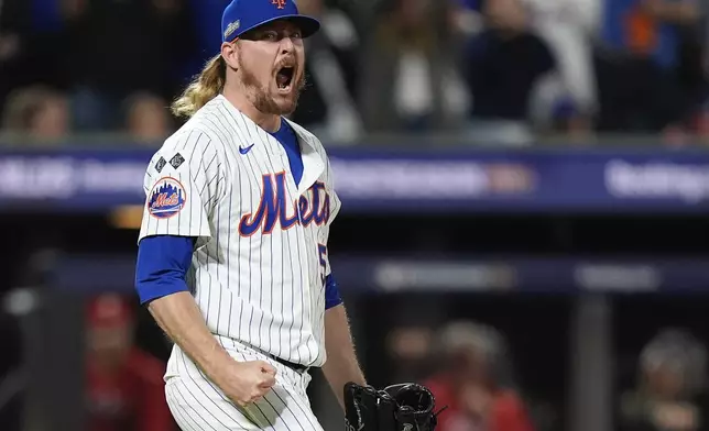 New York Mets pitcher Ryne Stanek (55) reacts after striking out the Philadelphia Phillies to end the ninth inning and Game 3 of the National League baseball playoff series, Tuesday, Oct. 8, 2024, in New York. (AP Photo/Frank Franklin II)