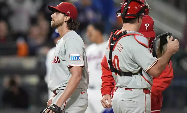 Philadelphia Phillies pitcher Aaron Nola (27) leaves the game during the sixth inning of Game 3 of the National League baseball playoff series against the New York Mets, Tuesday, Oct. 8, 2024, in New York. (AP Photo/Frank Franklin II)