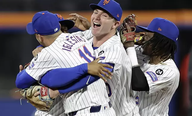 The New York Mets celebrate after defeating the Philadelphia Phillies in Game 4 of the National League baseball playoff series, Wednesday, Oct. 9, 2024, in New York. (AP Photo/Adam Hunger)