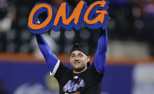 New York Mets second baseman Jose Iglesias celebrates on the field after the Mets beat the Philadelphia Phillies in Game 4 of the National League baseball playoff series, Wednesday, Oct. 9, 2024, in New York. (AP Photo/Adam Hunger)