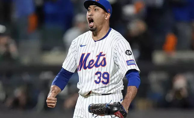 New York Mets pitcher Edwin Díaz (39) reacts after striking out the Philadelphia Phillies to end Game 4 of the National League baseball playoff series, Wednesday, Oct. 9, 2024, in New York. (AP Photo/Frank Franklin II)