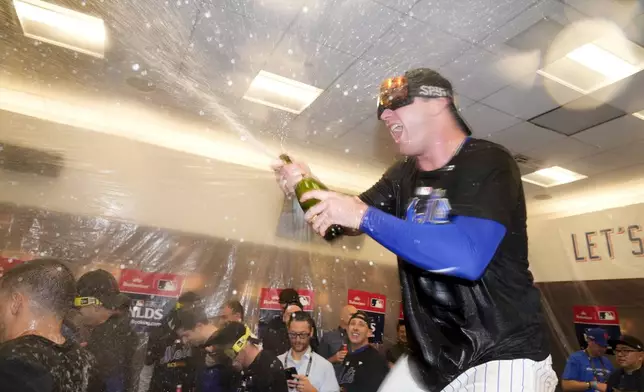 New York Mets' Pete Alonso celebrates in the locker room after defeating the Philadelphia Phillies in Game 4 of the National League baseball playoff series, Wednesday, Oct. 9, 2024, in New York. (AP Photo/Frank Franklin II)