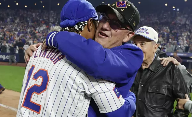 New York Mets shortstop Francisco Lindor (12) hugs owner Steve Cohen after the Mets defeated the Philadelphia Phillies in Game 4 of the National League baseball playoff series, Wednesday, Oct. 9, 2024, in New York. (AP Photo/Adam Hunger)