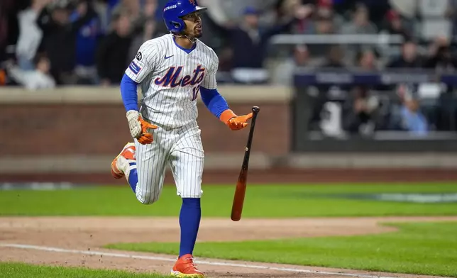 New York Mets' Francisco Lindor (12) drops his bat as he rounds the bases after hitting a grand slam home run against the Philadelphia Phillies during the sixth inning of Game 4 of the National League baseball playoff series, Wednesday, Oct. 9, 2024, in New York. (AP Photo/Frank Franklin II)