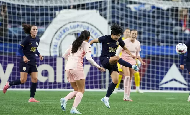 Seattle Reign midfielder Ji So-yun clears the ball against Angel City FC forward Christen Press, left, during the second half of an NWSL soccer match Friday, Oct. 4, 2024, in Seattle. Angel City won 1-0. (AP Photo/Lindsey Wasson)