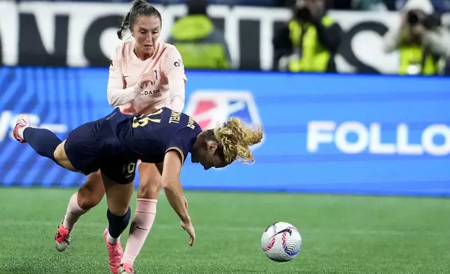 Seattle Reign midfielder Jaelin Howell, front, falls while colliding with Angel City FC midfielder Katie Zelem, back, during the second half of an NWSL soccer match Friday, Oct. 4, 2024, in Seattle. Angel City won 1-0. (AP Photo/Lindsey Wasson)