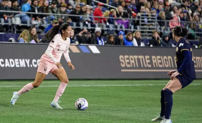 Angel City FC forward Christen Press looks on against Seattle Reign defender Phoebe McClernon, right, during the second half of an NWSL soccer match Friday, Oct. 4, 2024, in Seattle. Angel City won 1-0. (AP Photo/Lindsey Wasson)