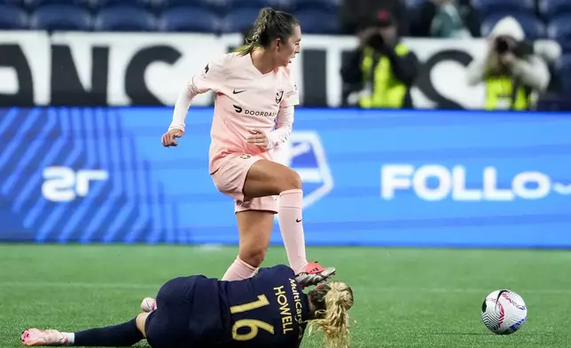 Seattle Reign midfielder Jaelin Howell (16) falls while colliding with Angel City FC midfielder Katie Zelem, back, during the second half of an NWSL soccer match Friday, Oct. 4, 2024, in Seattle. Angel City won 1-0. (AP Photo/Lindsey Wasson)