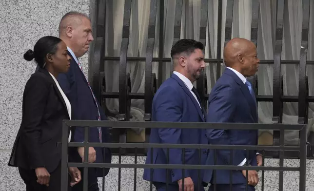 Eric Adams, right, walks into the federal courthouse n New York, Wednesday, Oct. 2, 2024. (AP Photo/Pamela Smith)