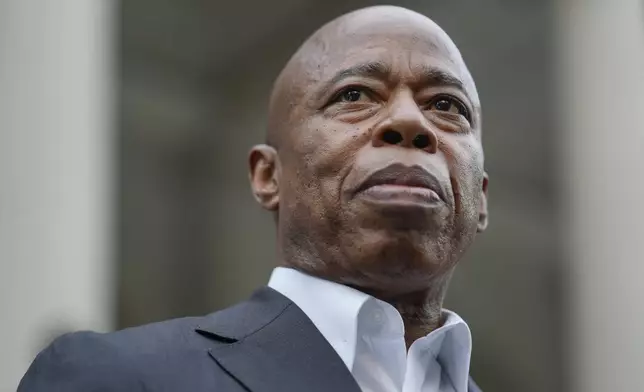 New York City Mayor Eric Adams looks on while surrounded by faith leaders and other supporters during a rally and prayer vigil on the steps of City Hall in New York, Tuesday, Oct. 1, 2024. (AP Photo/Seth Wenig)